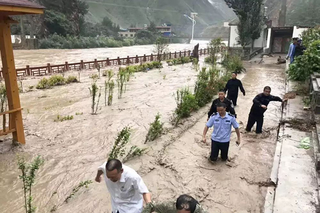 文县临江镇草坡村羊寺坝社遭受洪水侵袭,当地民警正在进行紧急抢险