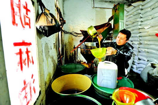 【图片新闻】天水市秦州区玉泉镇一家榨油坊店主在用